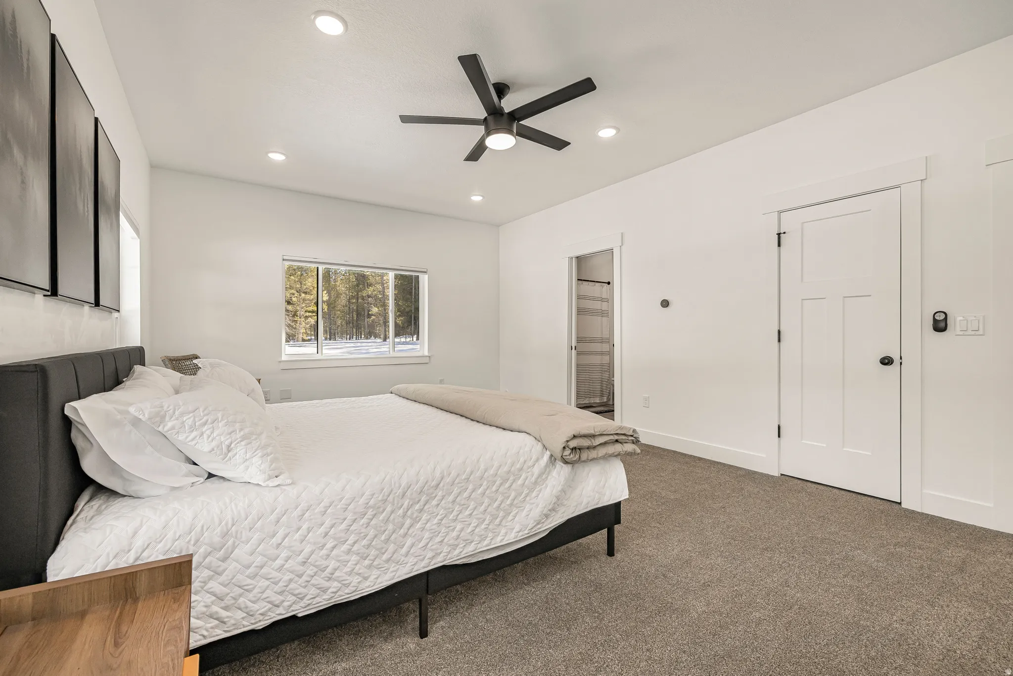 Bedroom with carpet floors, ceiling fan, ensuite bathroom, and recessed lighting