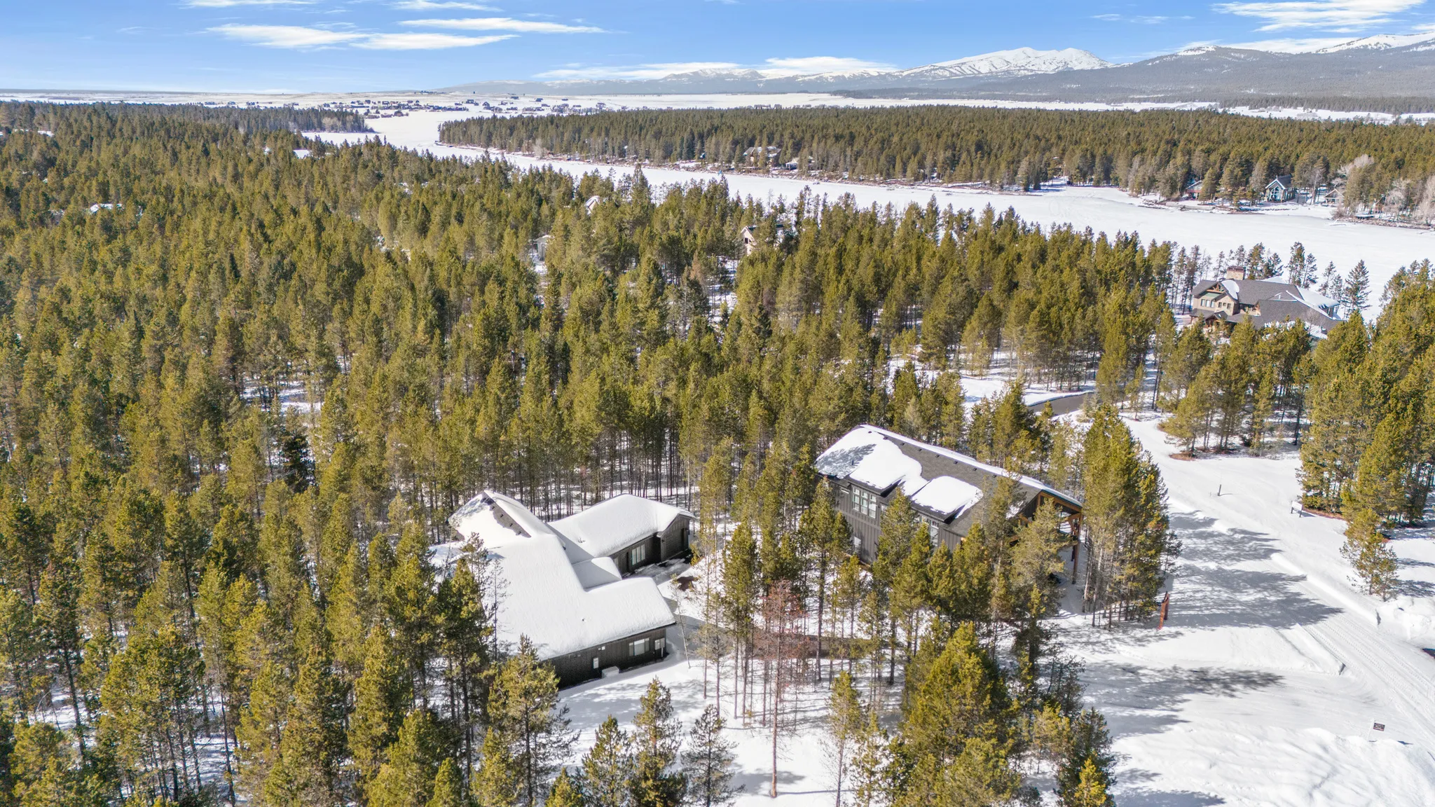 Snowy aerial view with a forest view and a mountain view