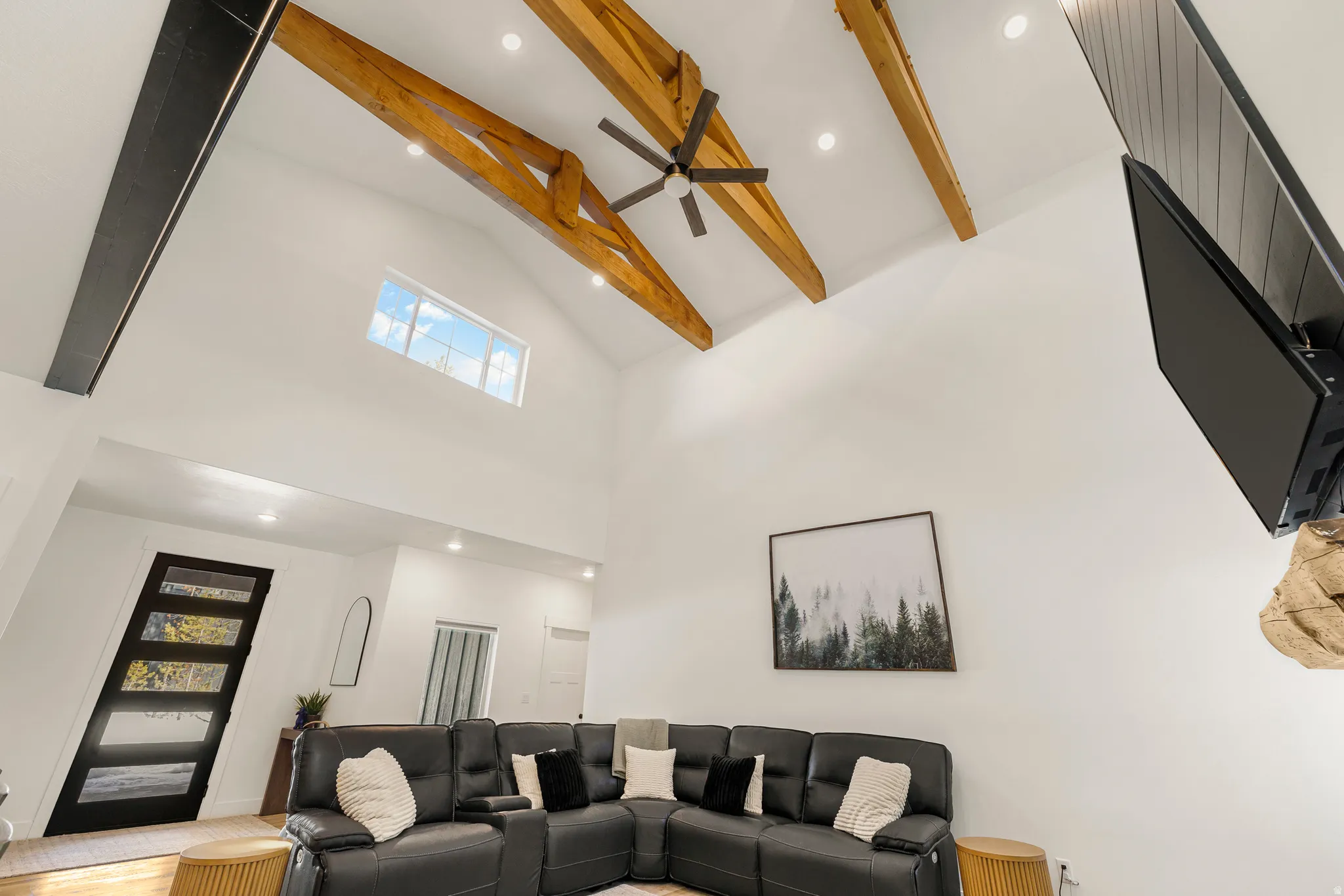 Living room with recessed lighting, lofted ceiling, and a ceiling fan