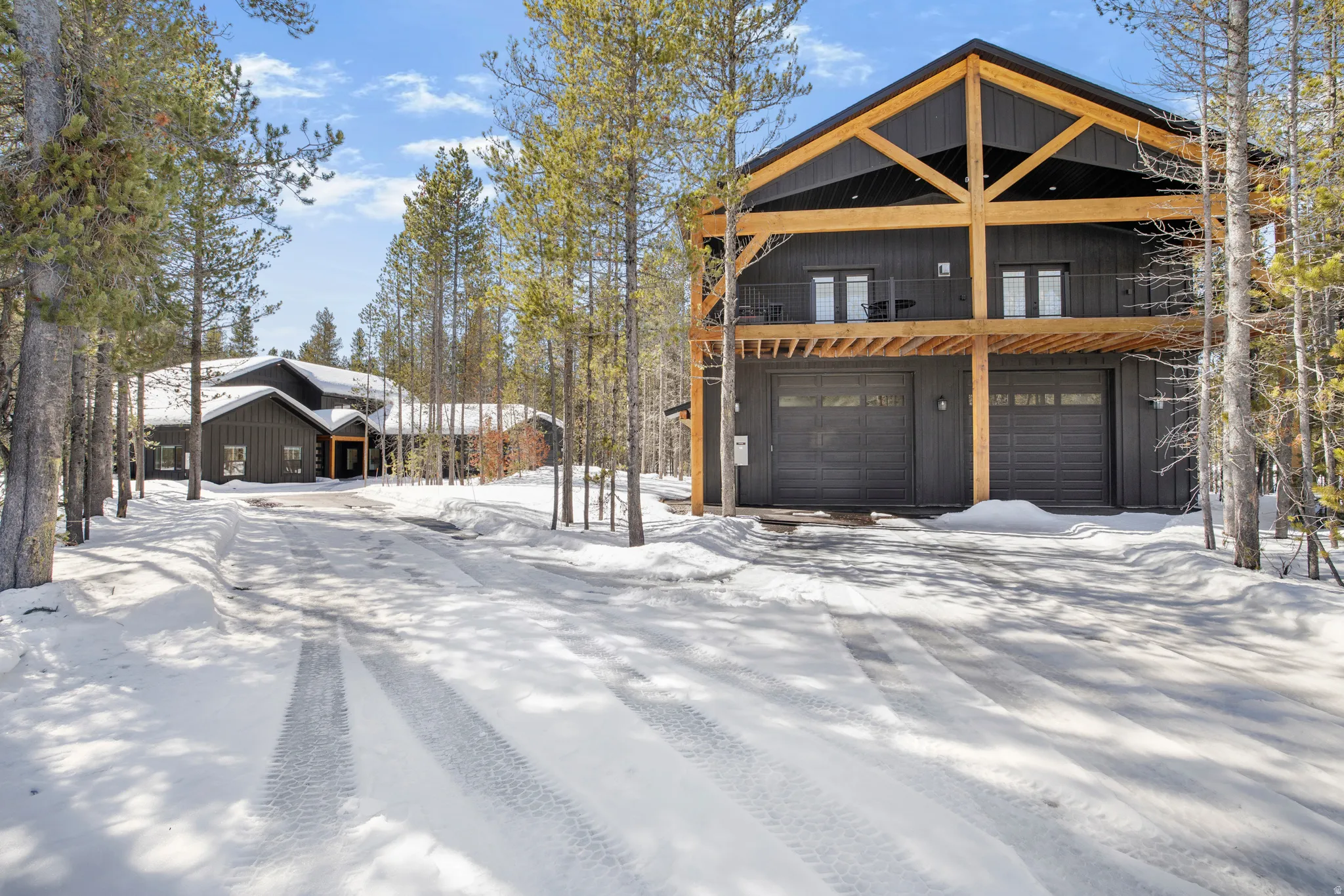 View of front of home featuring an attached garage and a balcony