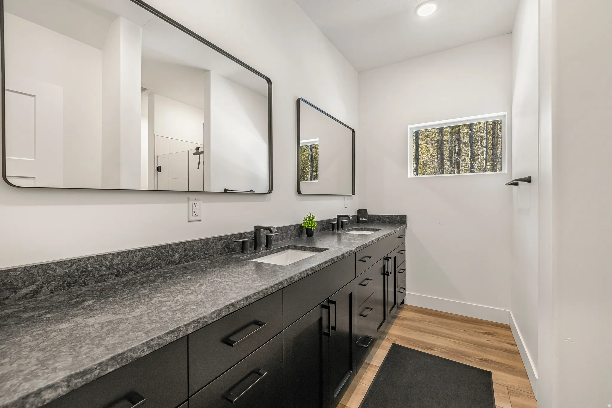 Full bath featuring light wood-style floors, double vanity, and recessed lighting