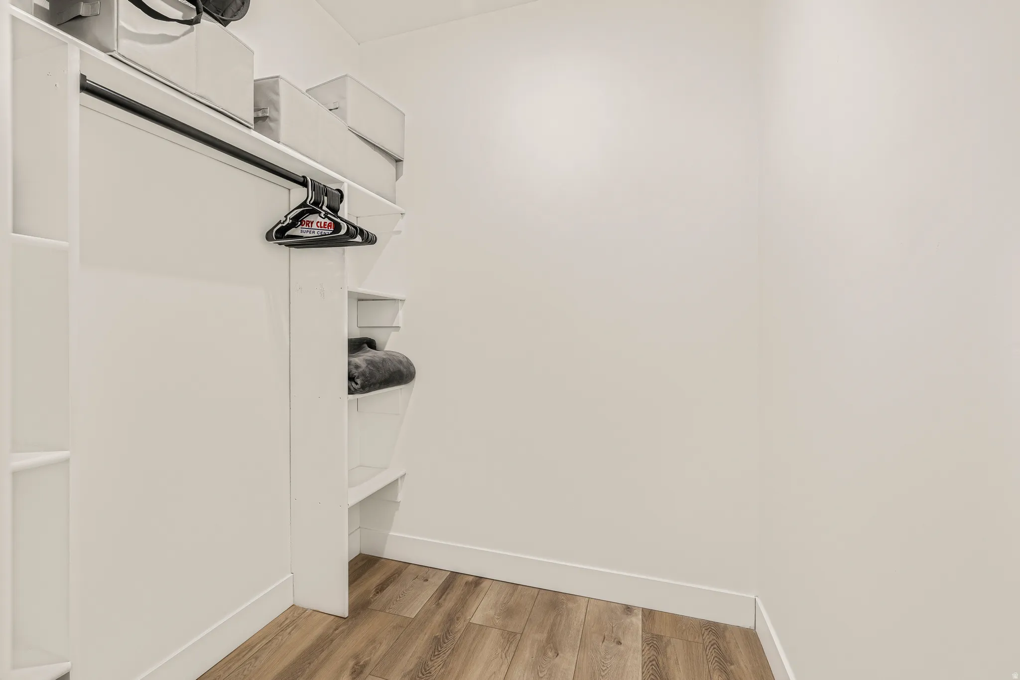 Walk in closet featuring light wood-type flooring