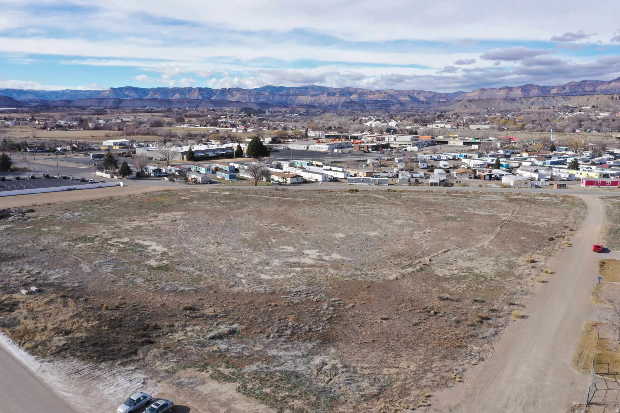 Aerial view of property's location featuring mountains and nearby suburban area