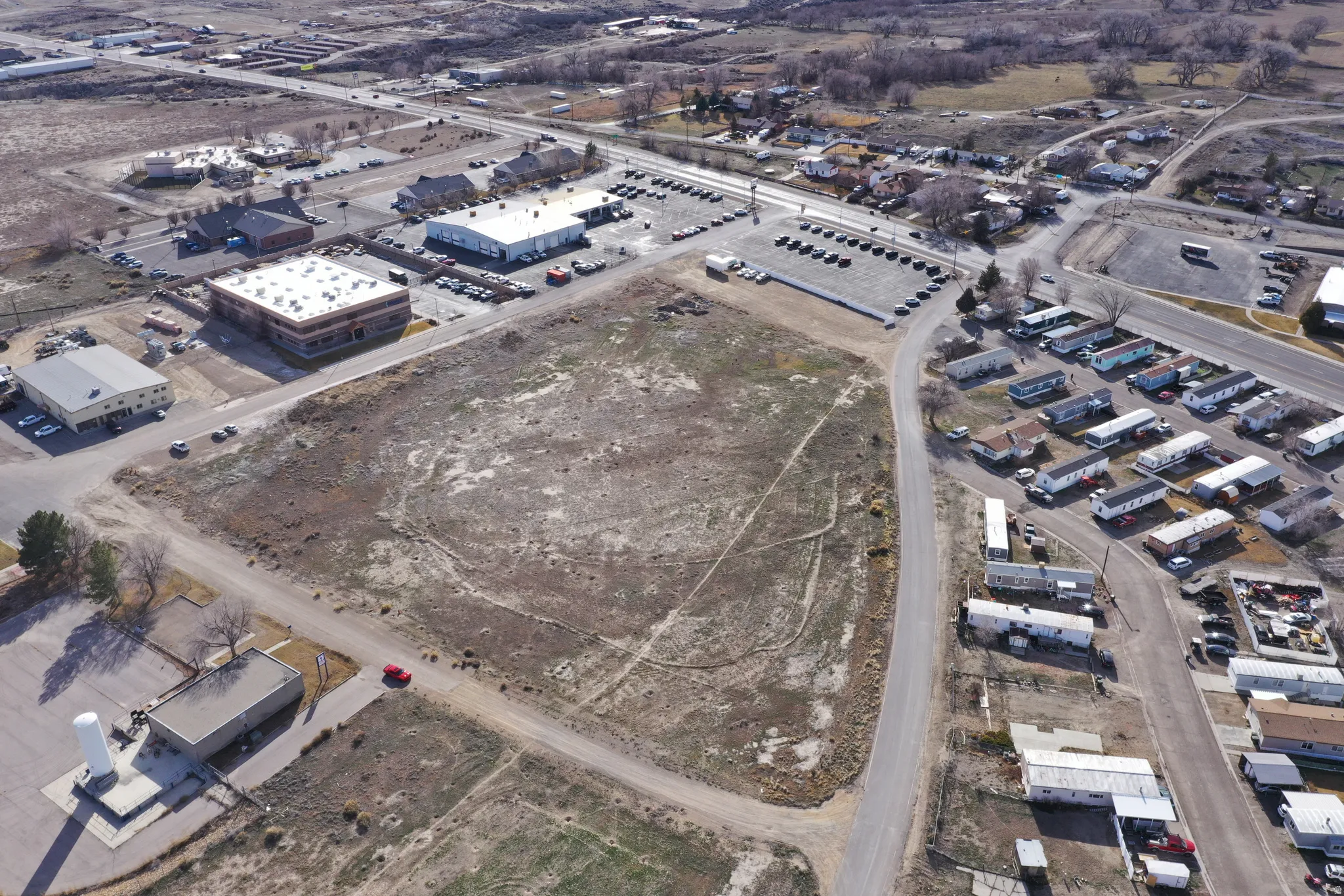 Aerial view of property and surrounding area with an industrial area