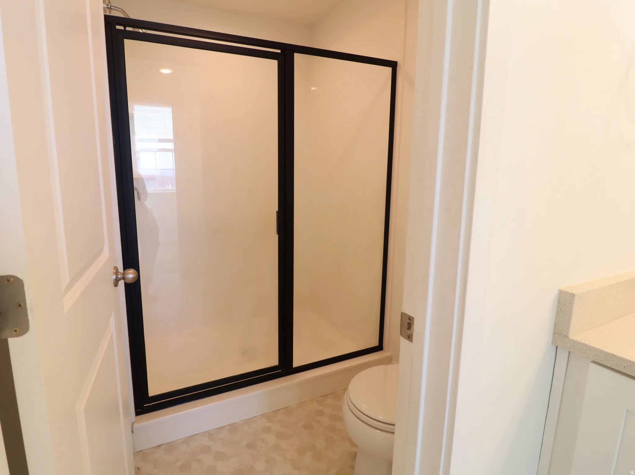 Bathroom with a shower stall and vanity