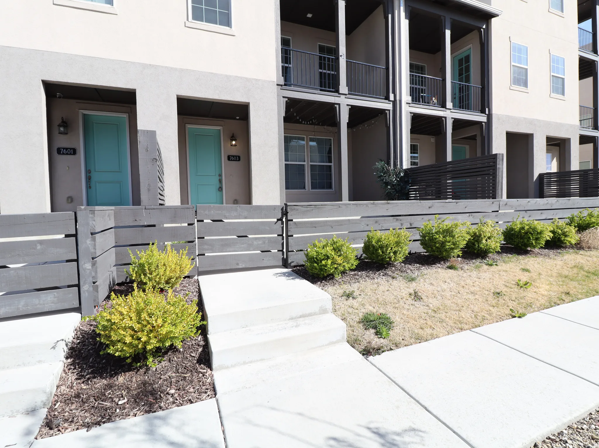 Property entrance featuring stucco siding and a gate