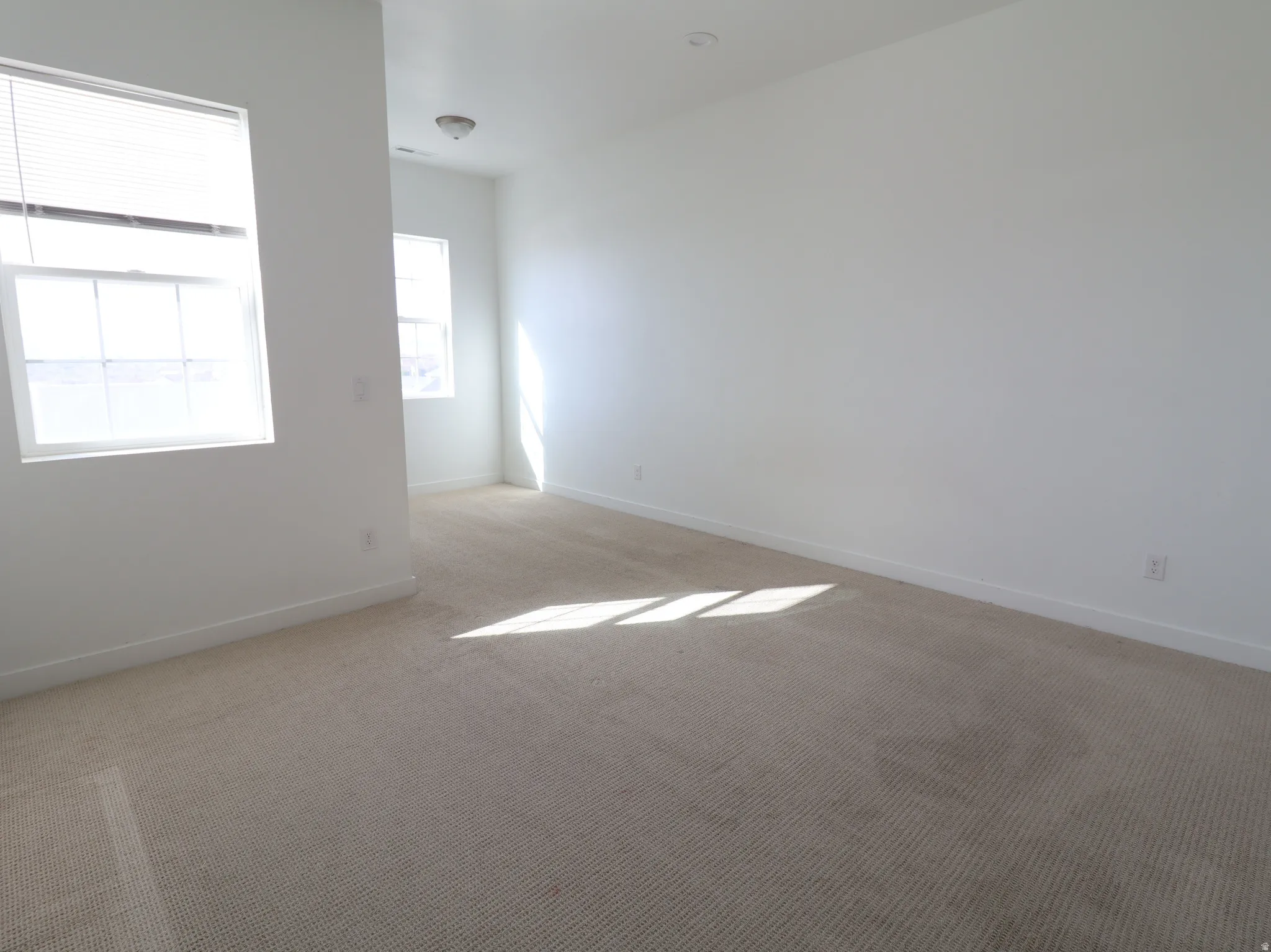 Carpeted empty room featuring baseboards