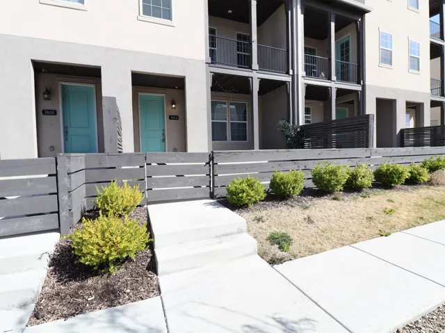 Property entrance featuring stucco siding and a gate