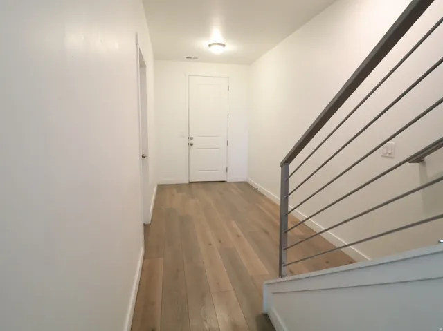 Hallway featuring baseboards and light wood finished floors