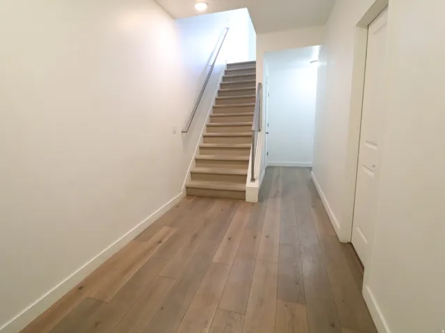 Stairs featuring baseboards and hardwood / wood-style flooring