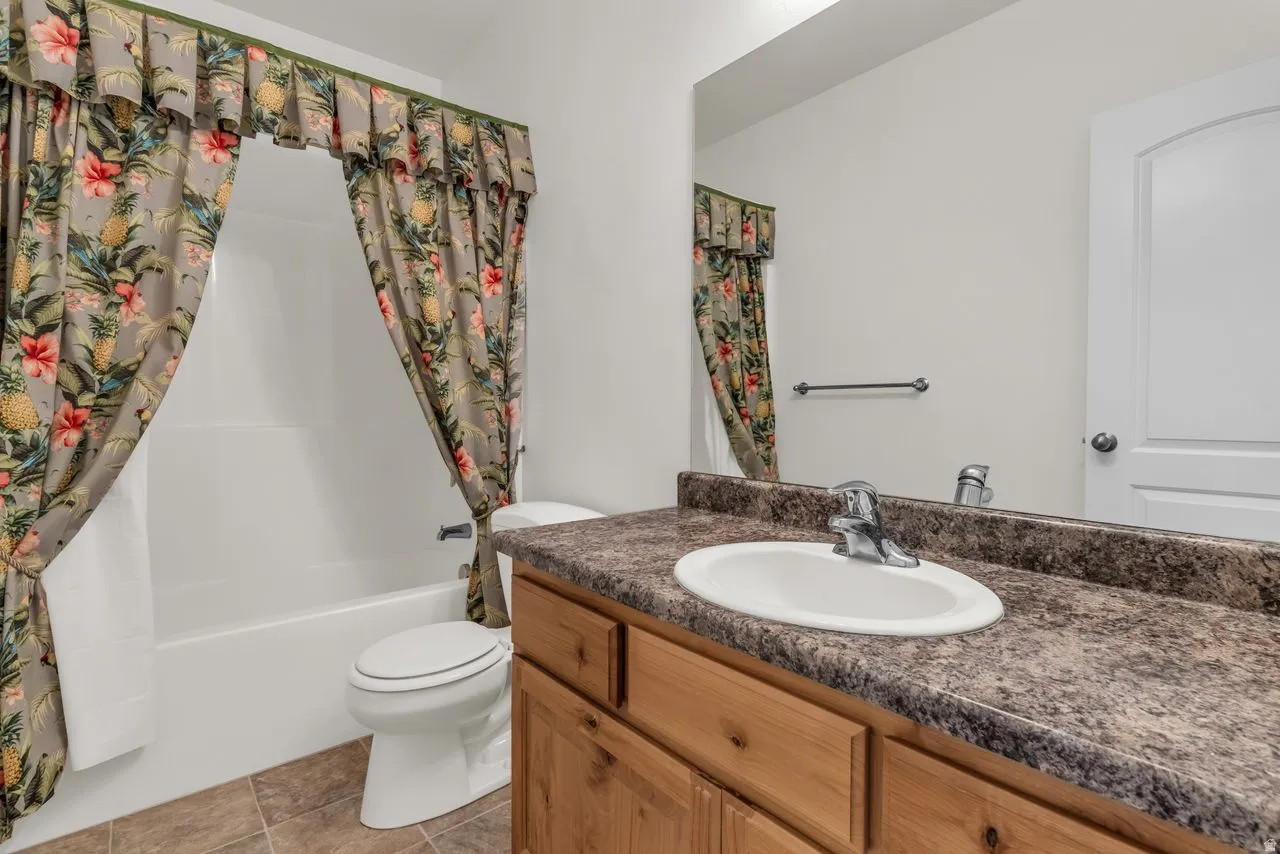 Full bathroom with vanity and shower / bath combination with curtain