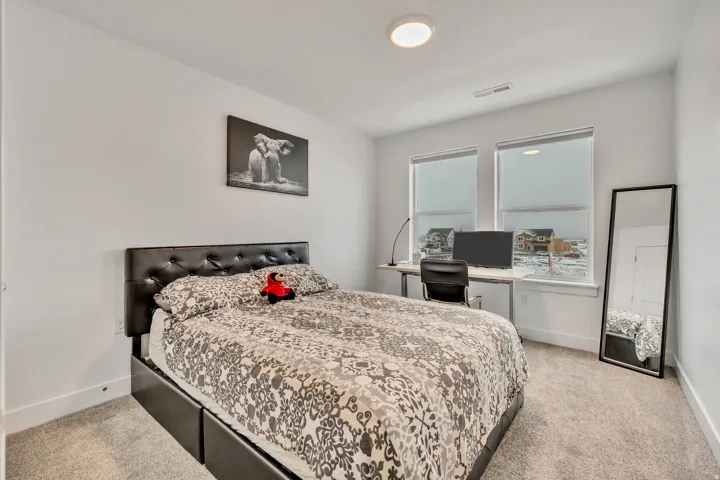 Bedroom with light colored carpet
