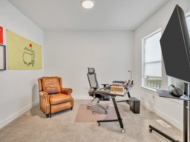 Carpeted office with baseboards