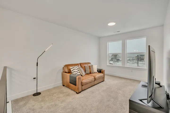 Sitting room featuring carpet and baseboards