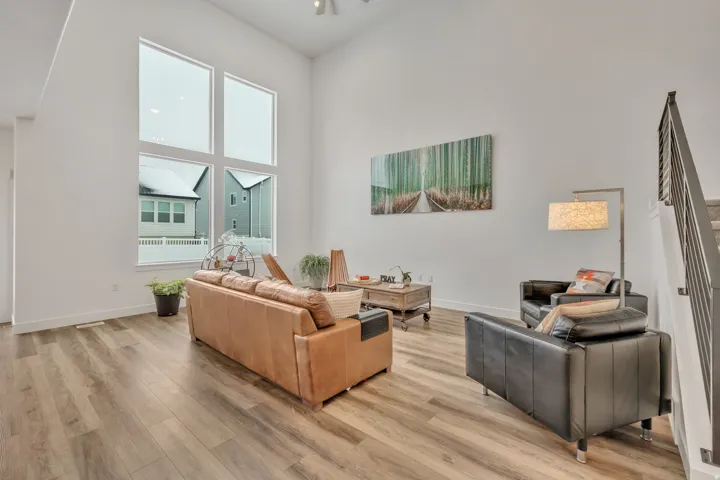 Living room featuring light wood finished floors and a high ceiling