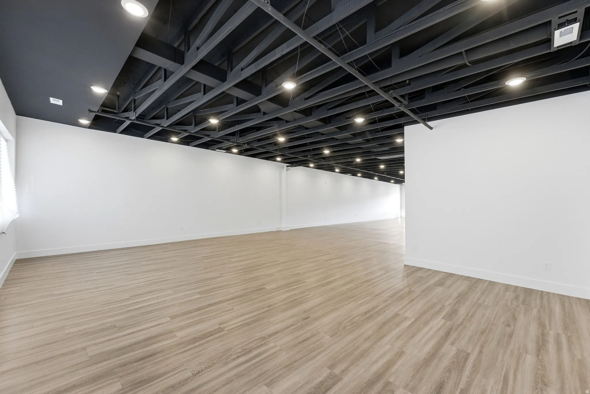 Empty room featuring light wood finished floors and baseboards