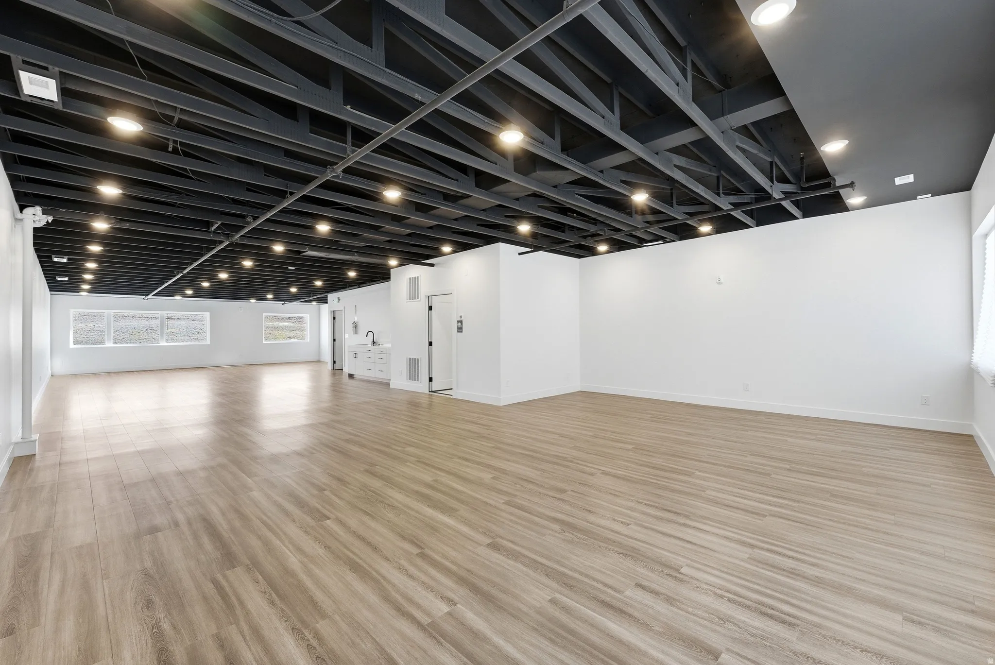 Unfurnished room with light wood-style floors and baseboards