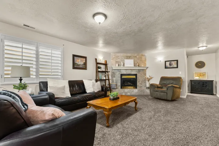 Family area with a fireplace, and windows for natural light