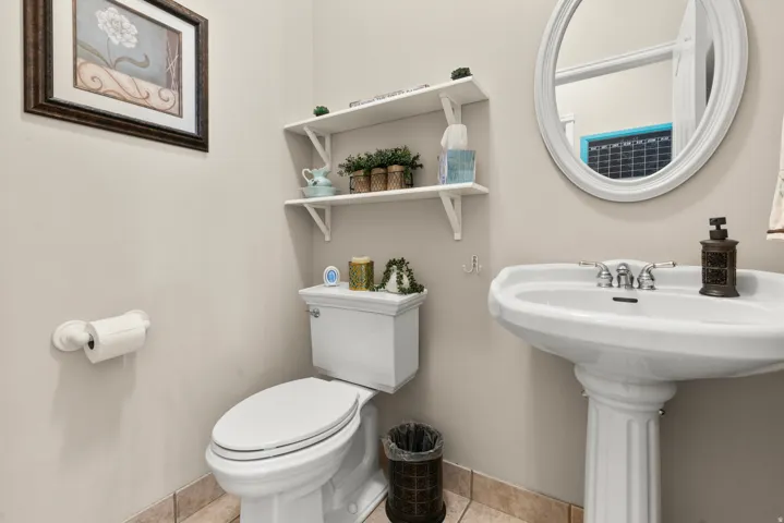 Half bathroom with light tile floors