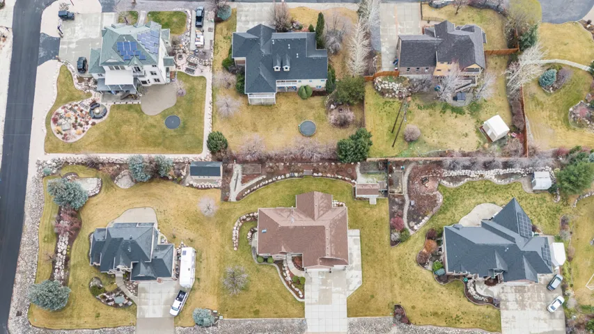 Aerial view of property and surrounding area with nearby neighborhood