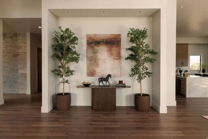 Wood-finish flooring throughout, recessed lighting, and a stone accent wall