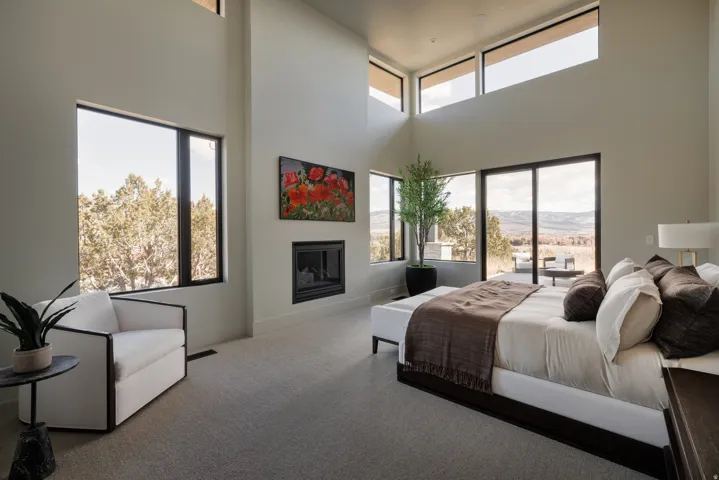 Vaulted ceilings with clerestory windows, large format windows, built-in fireplace, and direct access to an outdoor area