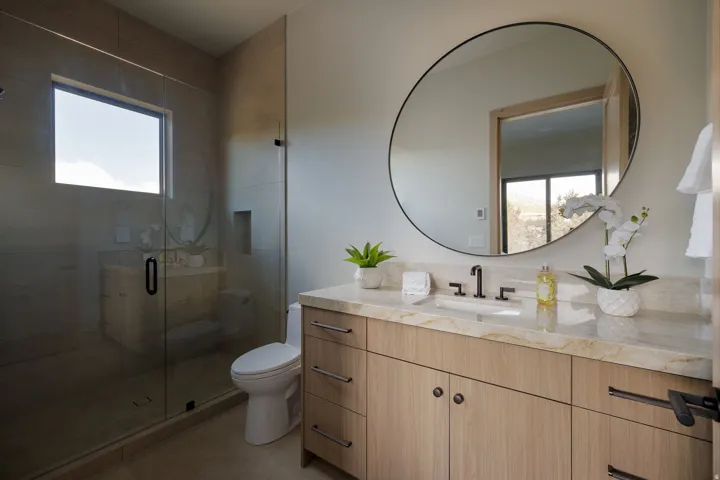 Glass-enclosed shower with a transom window