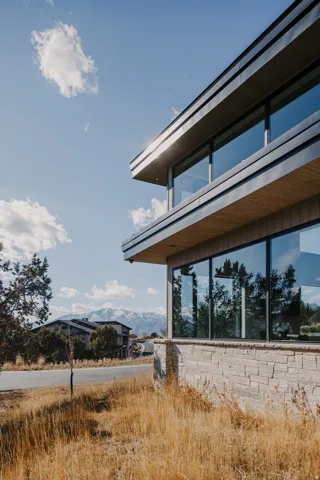 Contemporary exterior with stone veneer, extensive glazing, and clean architectural lines