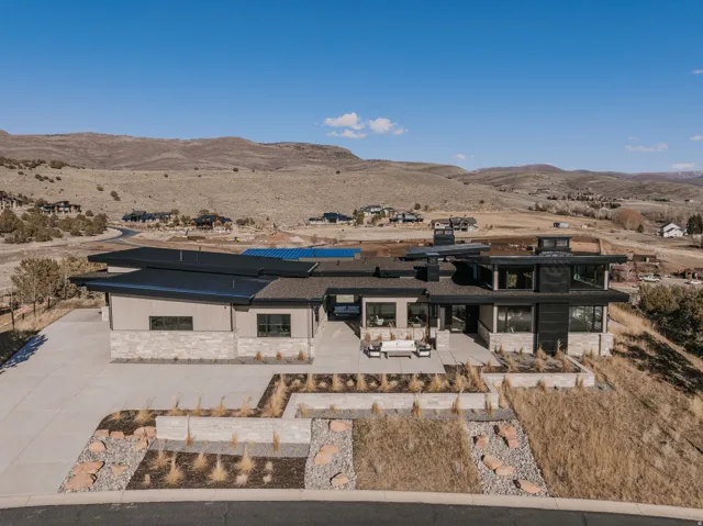Contemporary architecture featuring a multi-level roofline and stone and dark paneling exterior
