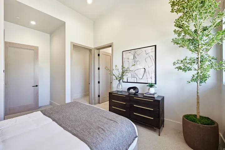 Recessed lighting, wood-finish doors, and light-toned walls