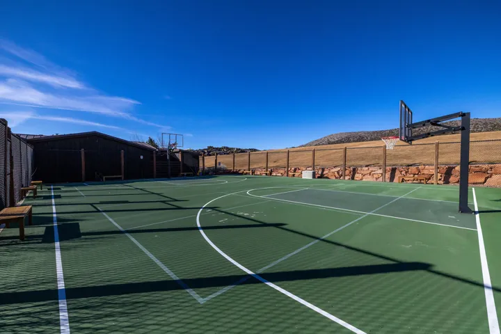 Multi-sport court with green surfacing and white line markings