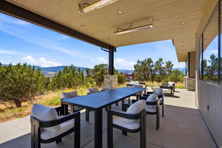 Expansive covered patio featuring a wood-finish ceiling, recessed lighting, and integrated heaters