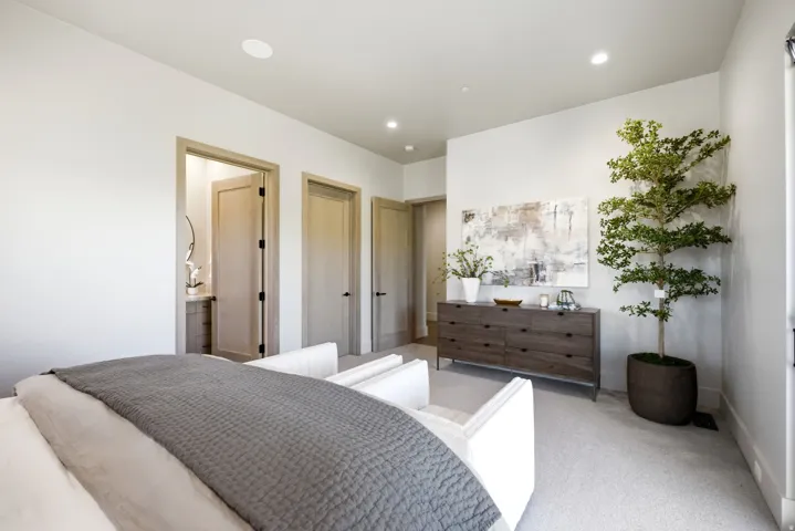 Recessed lighting, light-toned walls, and multiple doorways with light wood-finish doors