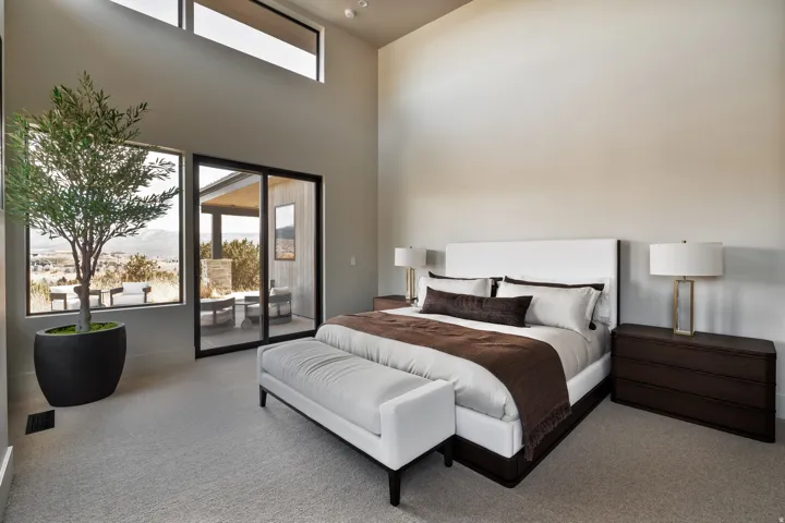 Expansive room with high ceilings, large windows, and a sliding glass door