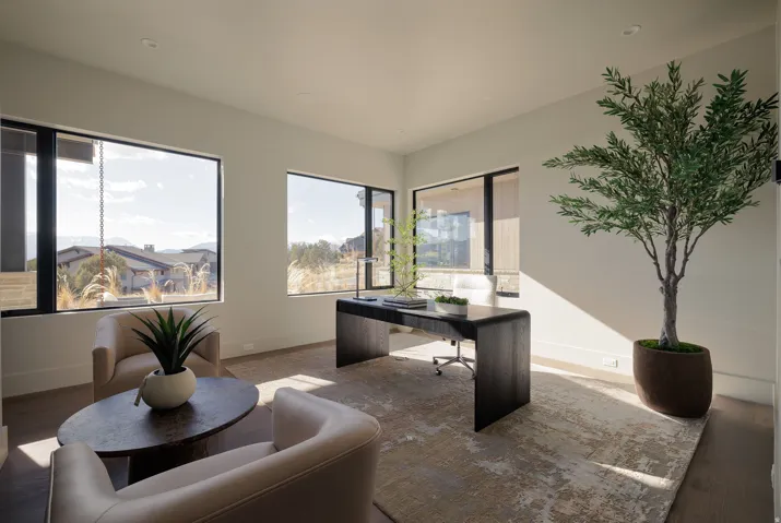 Spacious room with multiple large windows and recessed lighting