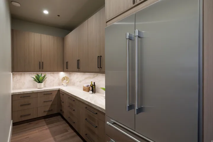 Built-in full-height refrigerator with stainless steel finish and bar handles