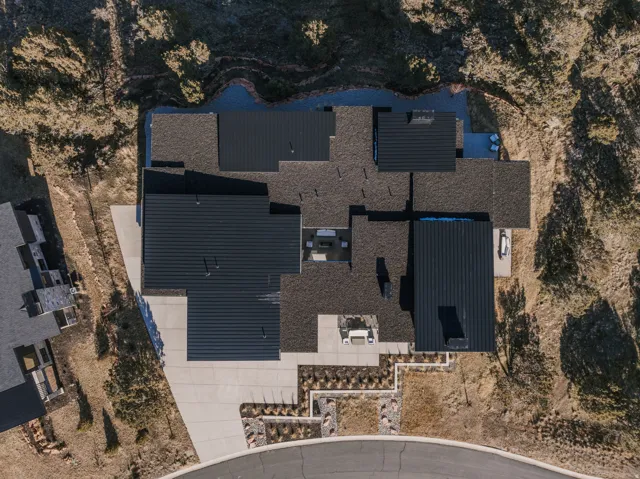 Architectural roof featuring multiple gables and dark metal roofing sections