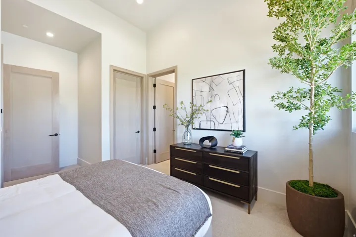 Neutral wall colors, recessed lighting, light wood-finish doors with black hardware, and carpeted flooring