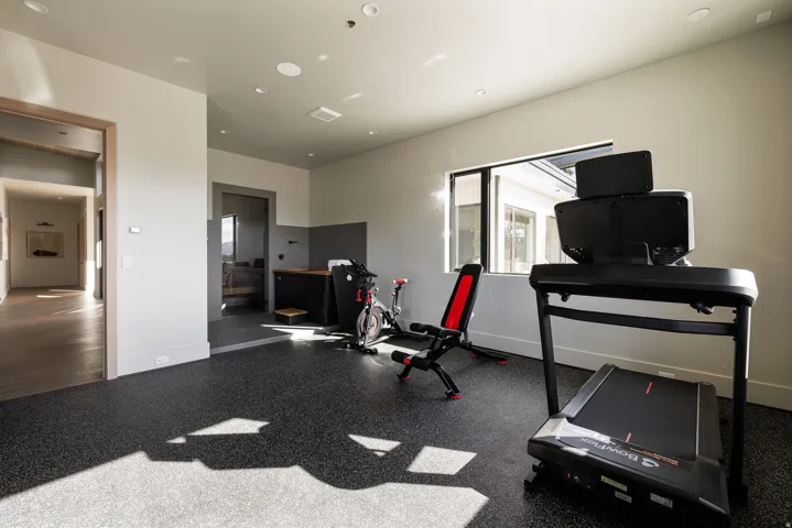 Specialty room with durable speckled flooring, recessed lighting, and a large window