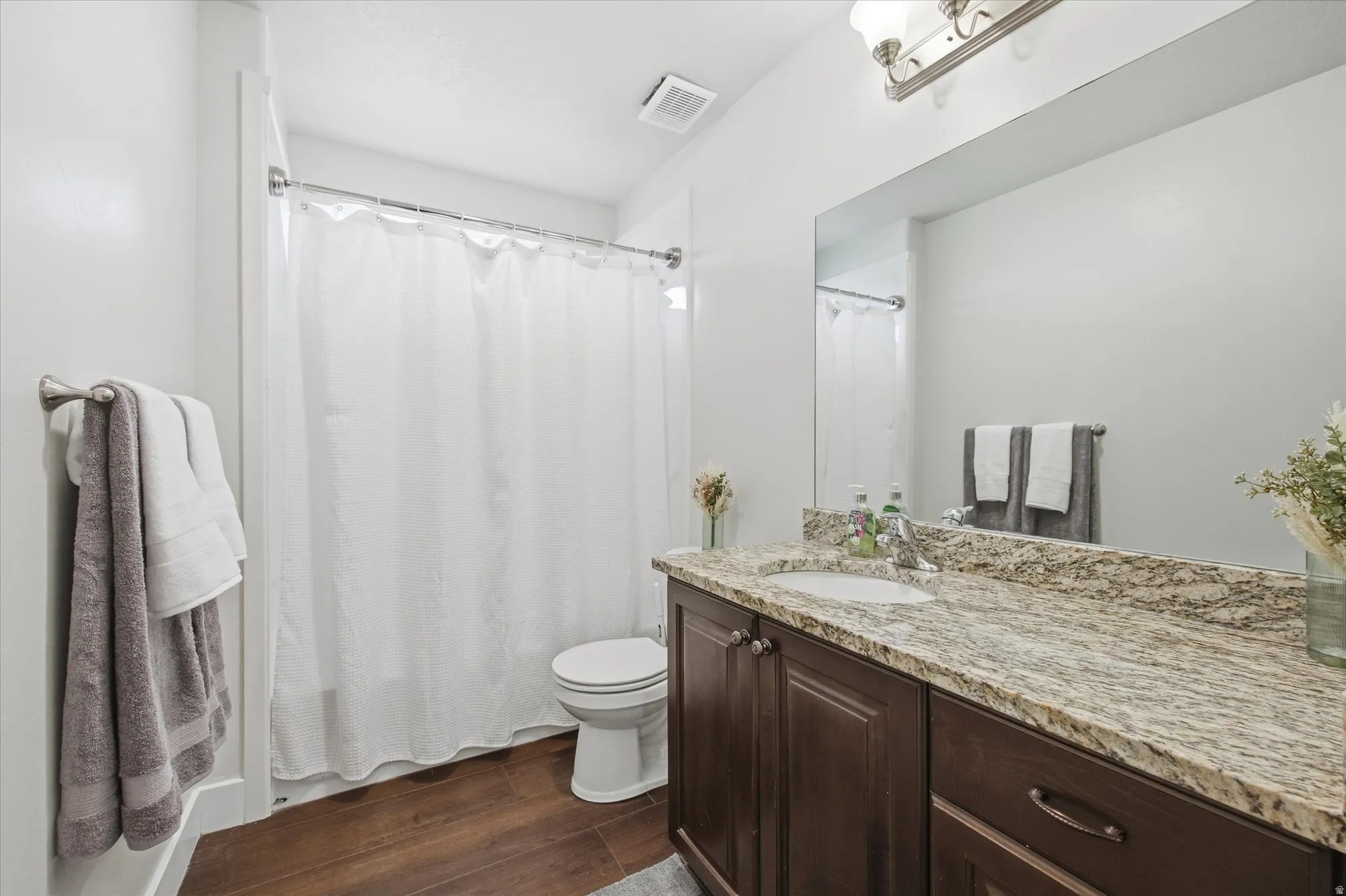 Bathroom featuring vanity and dark wood finished floors