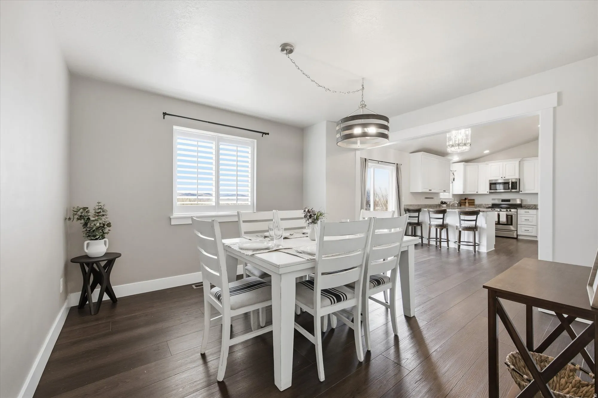 Dining room featuring dark wood finished floors and lofted ceiling