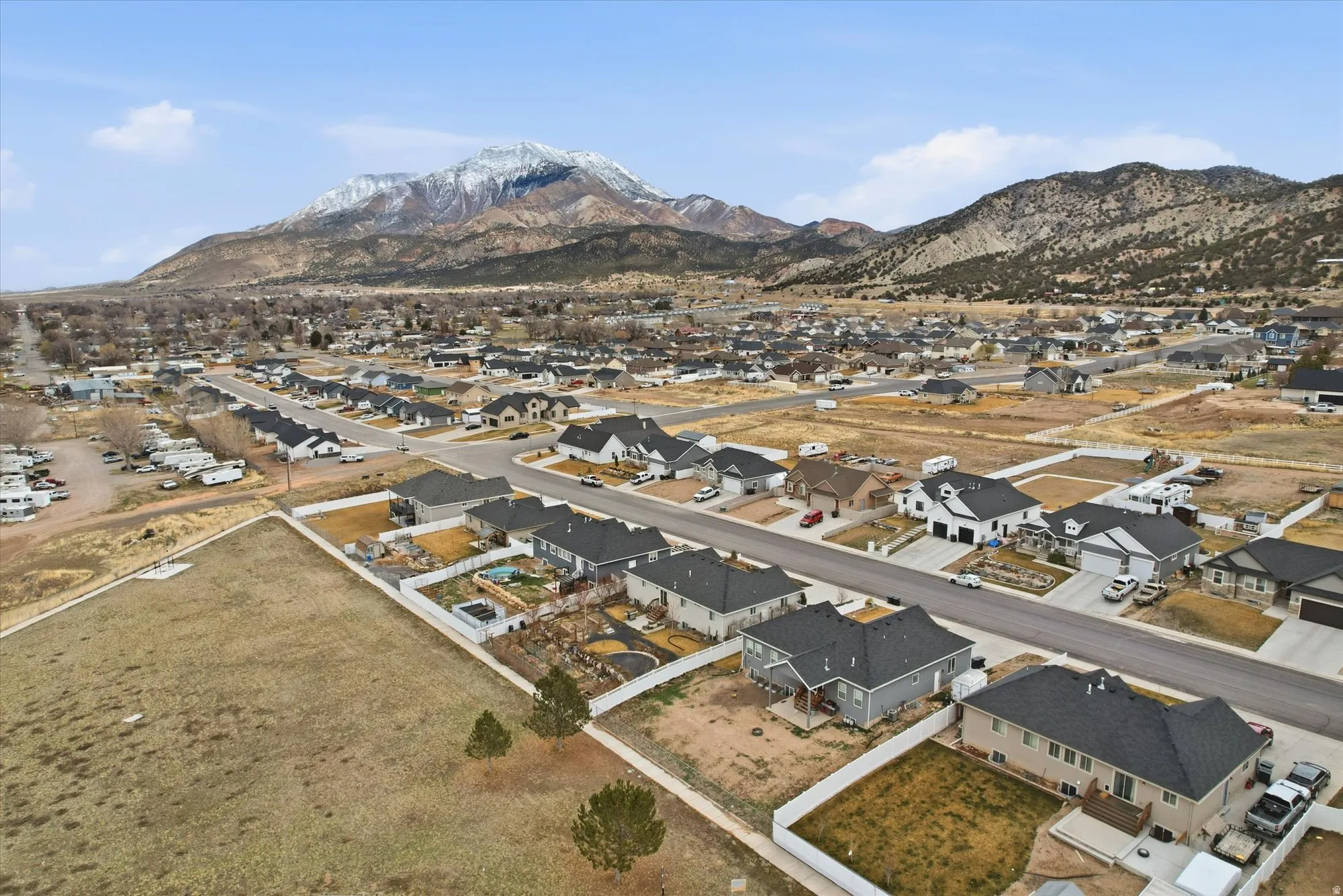 Aerial overview of property's location featuring nearby suburban area and a mountain backdrop