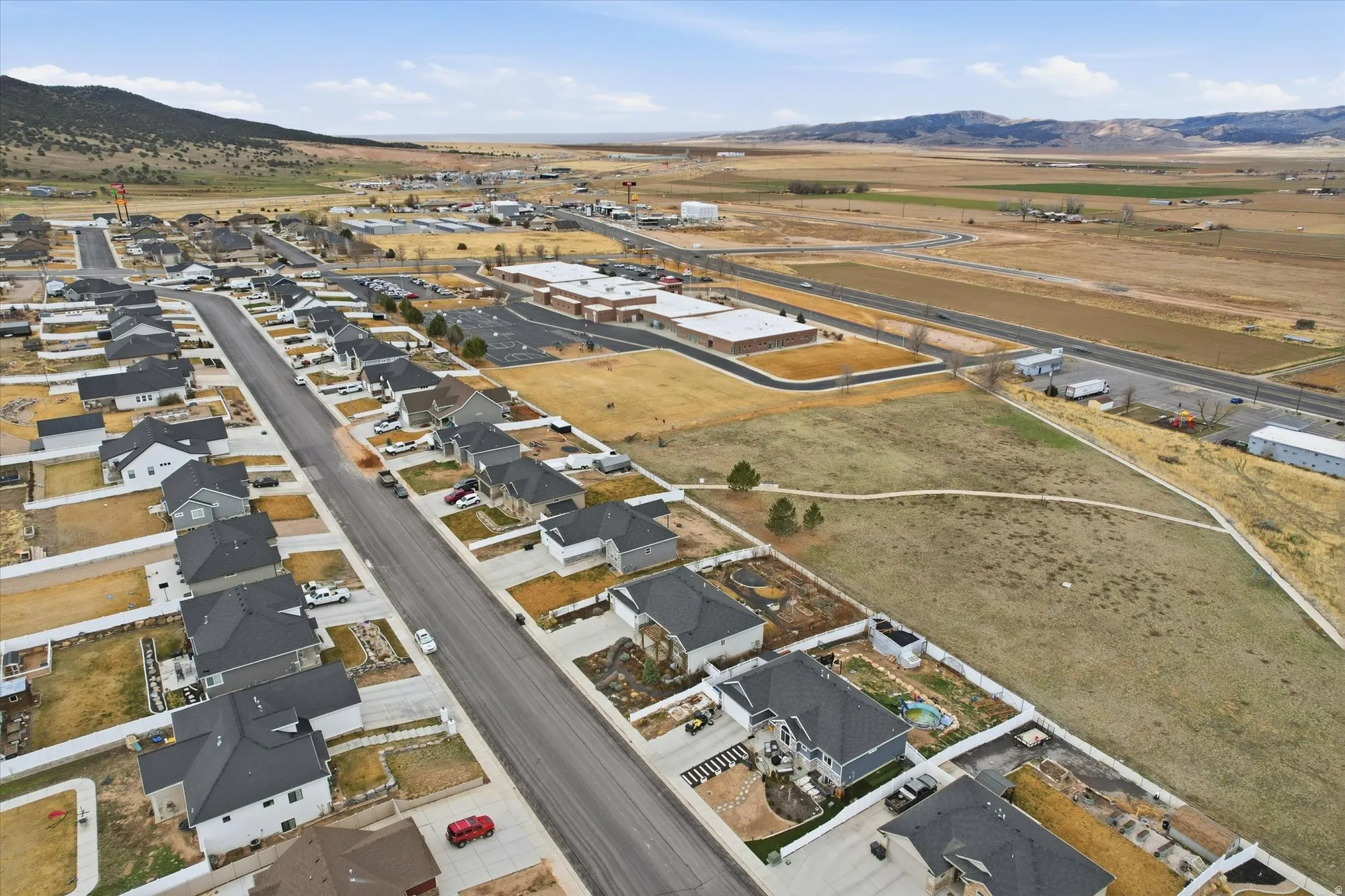 Aerial view of property's location with a mountainous background and nearby suburban area