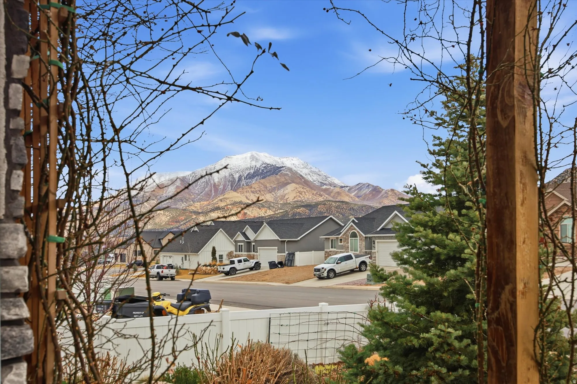 View of mountain backdrop featuring nearby suburban area
