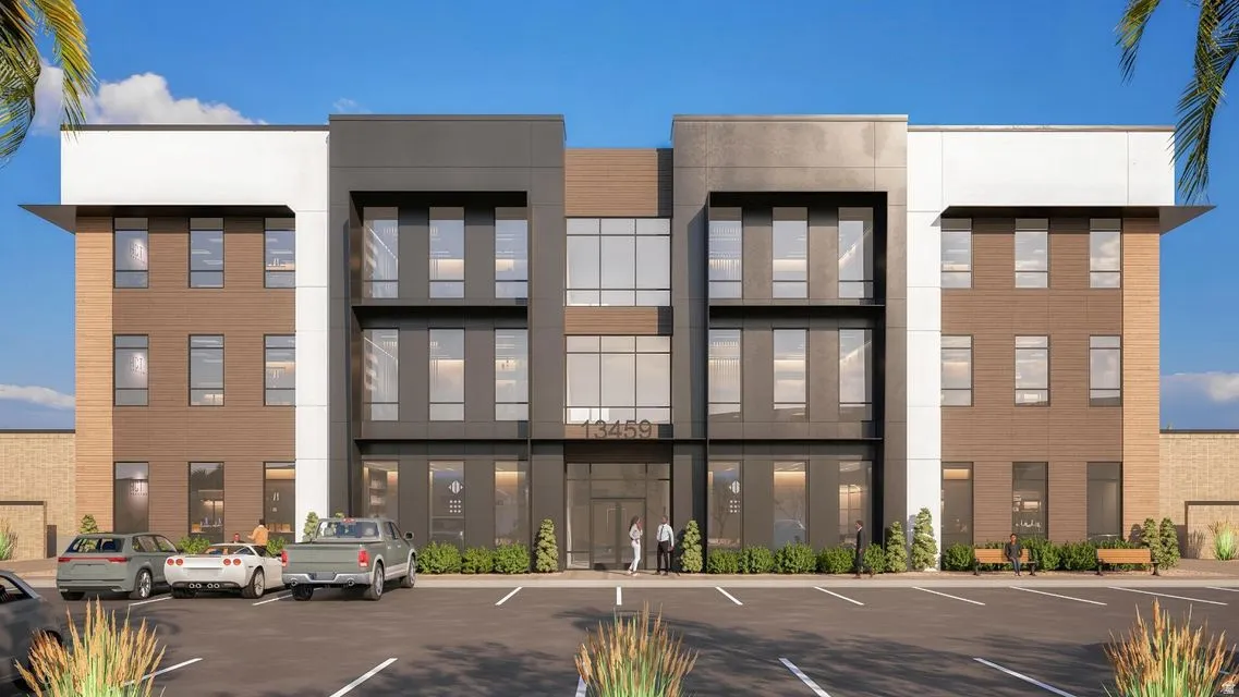 View of building exterior featuring uncovered parking