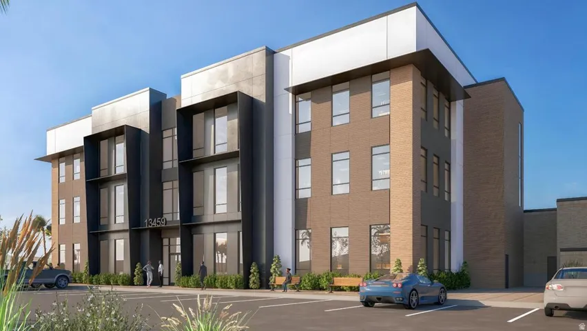 View of apartment building / complex featuring uncovered parking