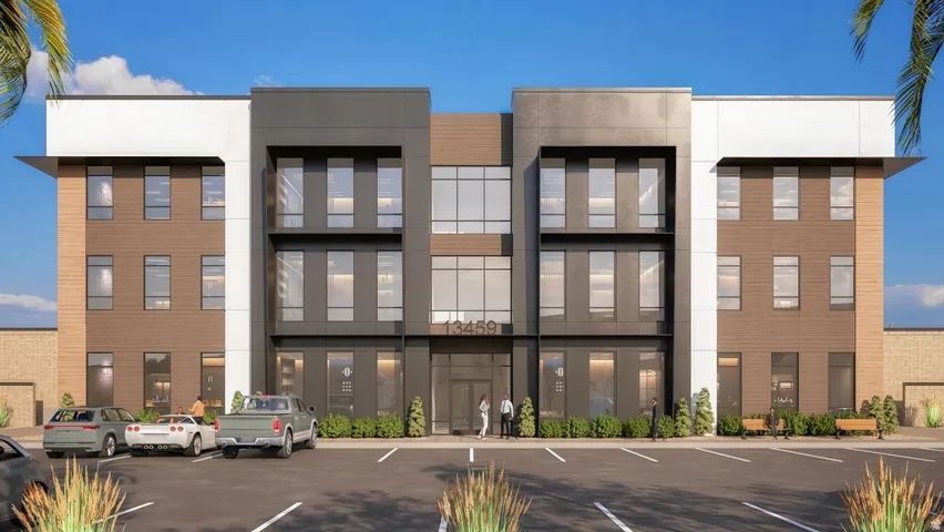 View of building exterior featuring uncovered parking