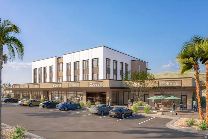 View of commercial property with uncovered parking