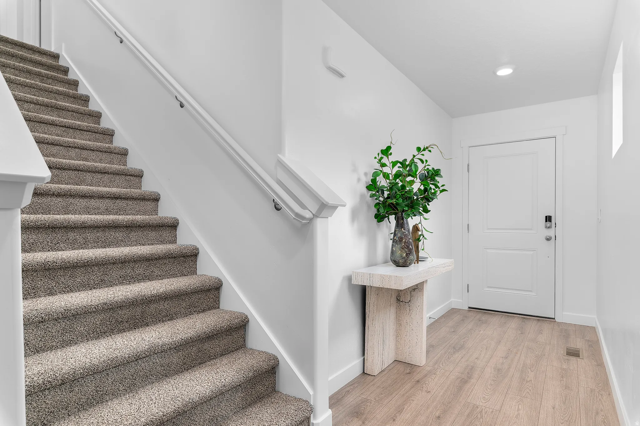 Entrance foyer featuring stairway and light wood finished floors