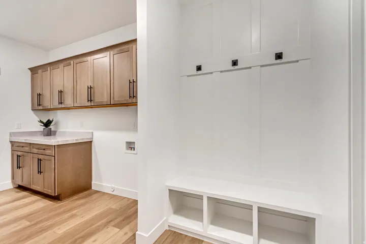 Laundry area featuring light wood-type flooring, hookup for a washing machine, and cabinet space